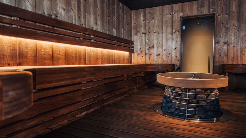 Warm wooden sauna interior &mdash; red light therapy vs. infrared sauna